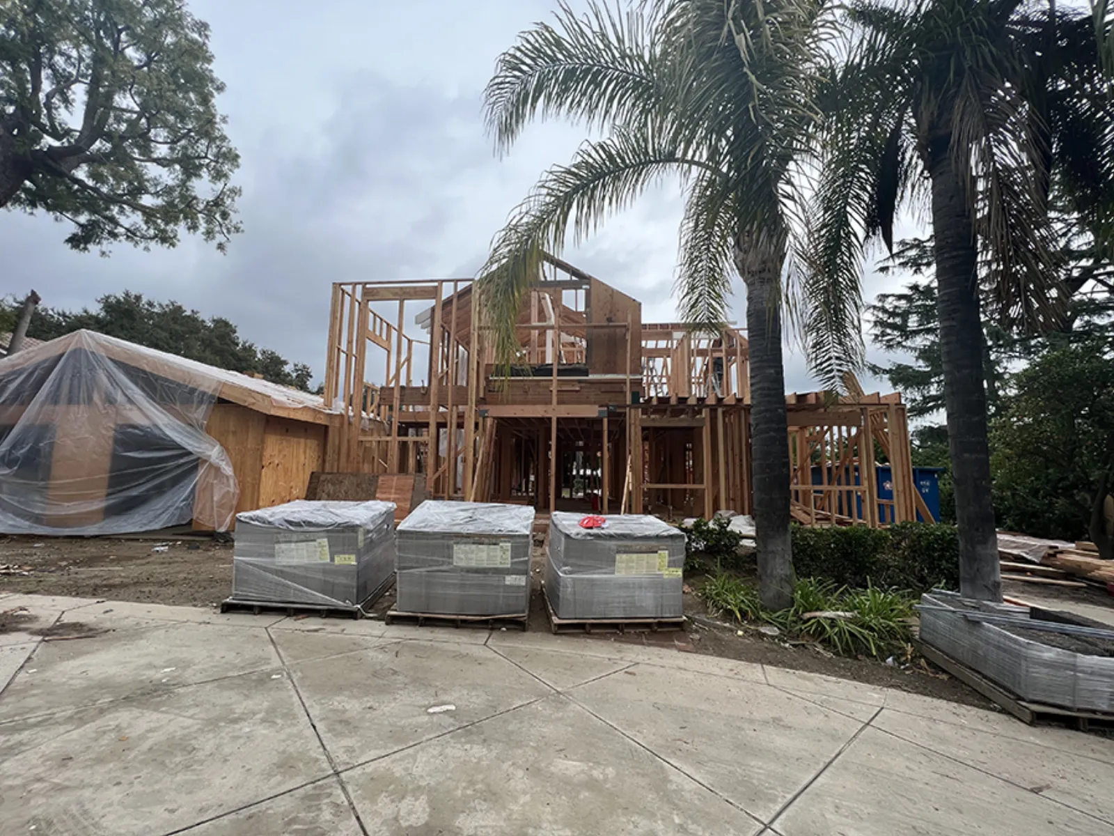 Chevy Chase new construction, two-story framing from the street, materials staged, La Cañada Flintridge