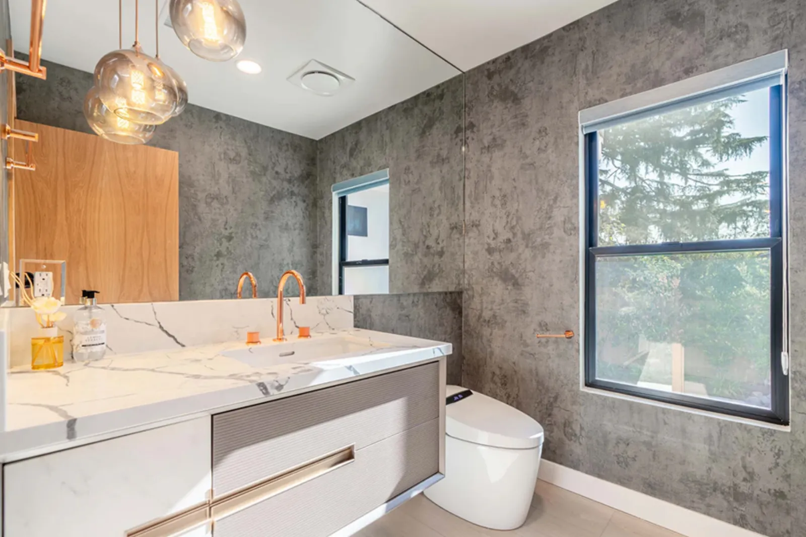 Finished bathroom with a marble vanity and brass fixtures from a PMK Development new-construction project in La Cañada Flintridge