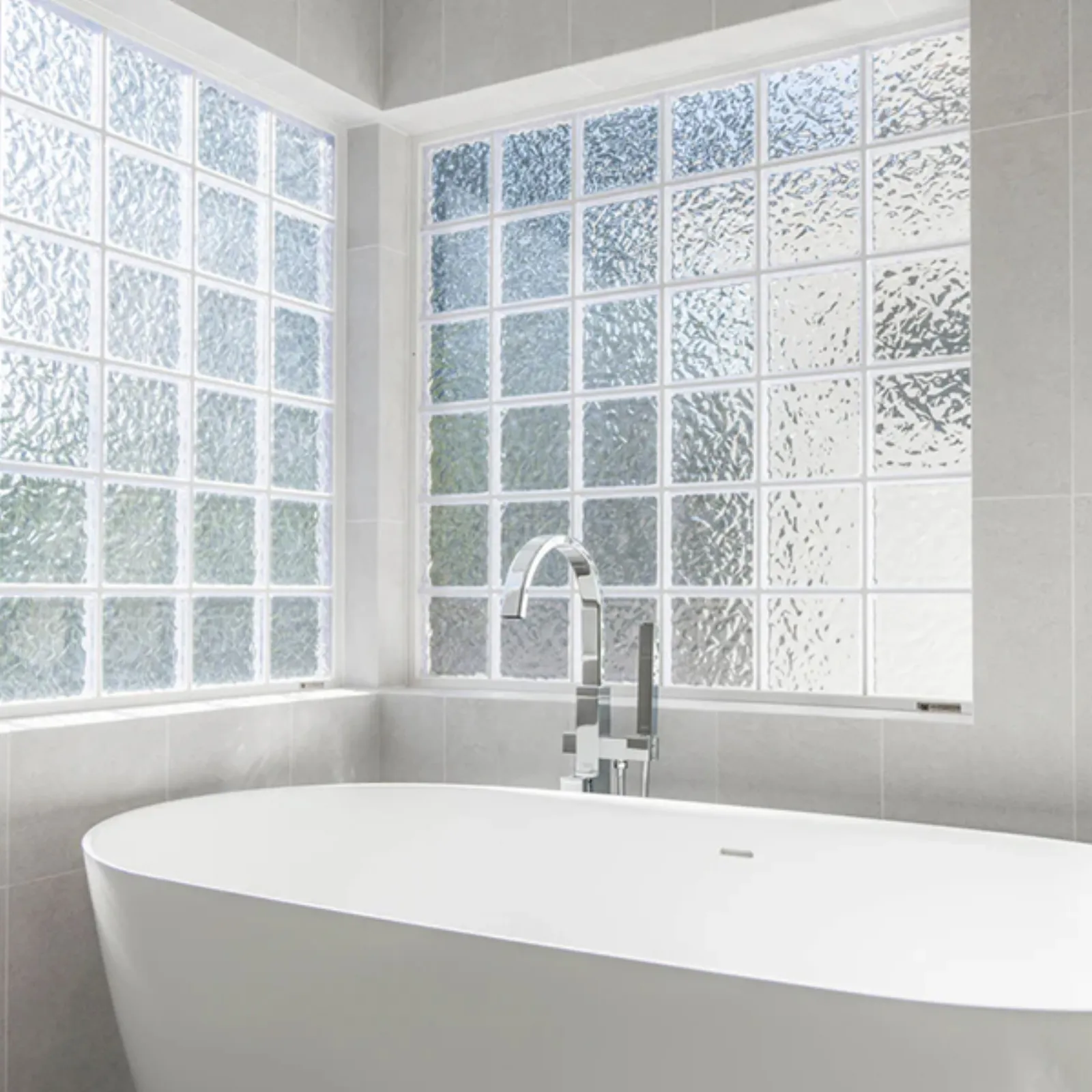 Chevy Chase ground-up build, finished primary bath with freestanding tub and glass block windows, La Cañada Flintridge