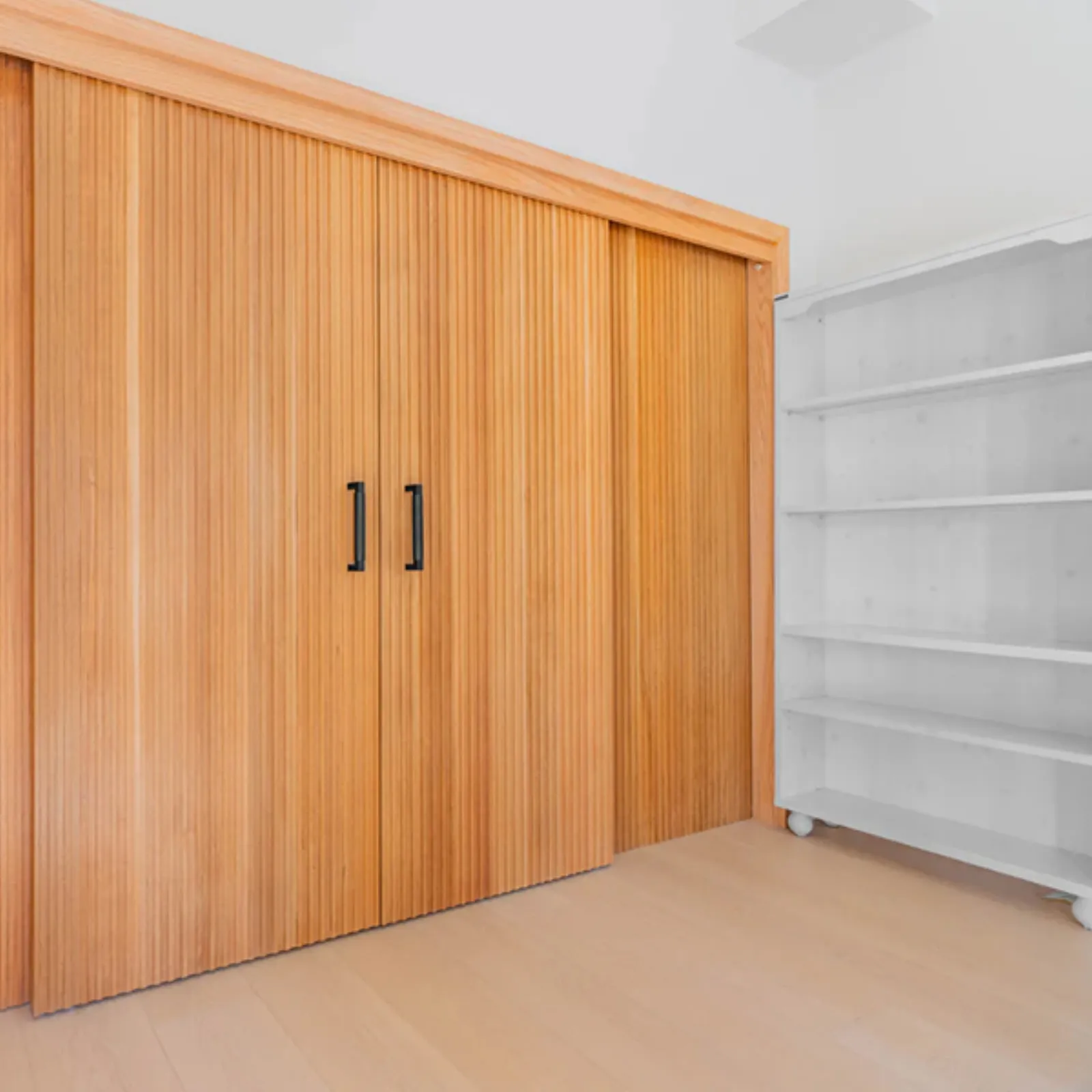 Chevy Chase ground-up build, finished built-in closet with wood slat doors, La Cañada Flintridge