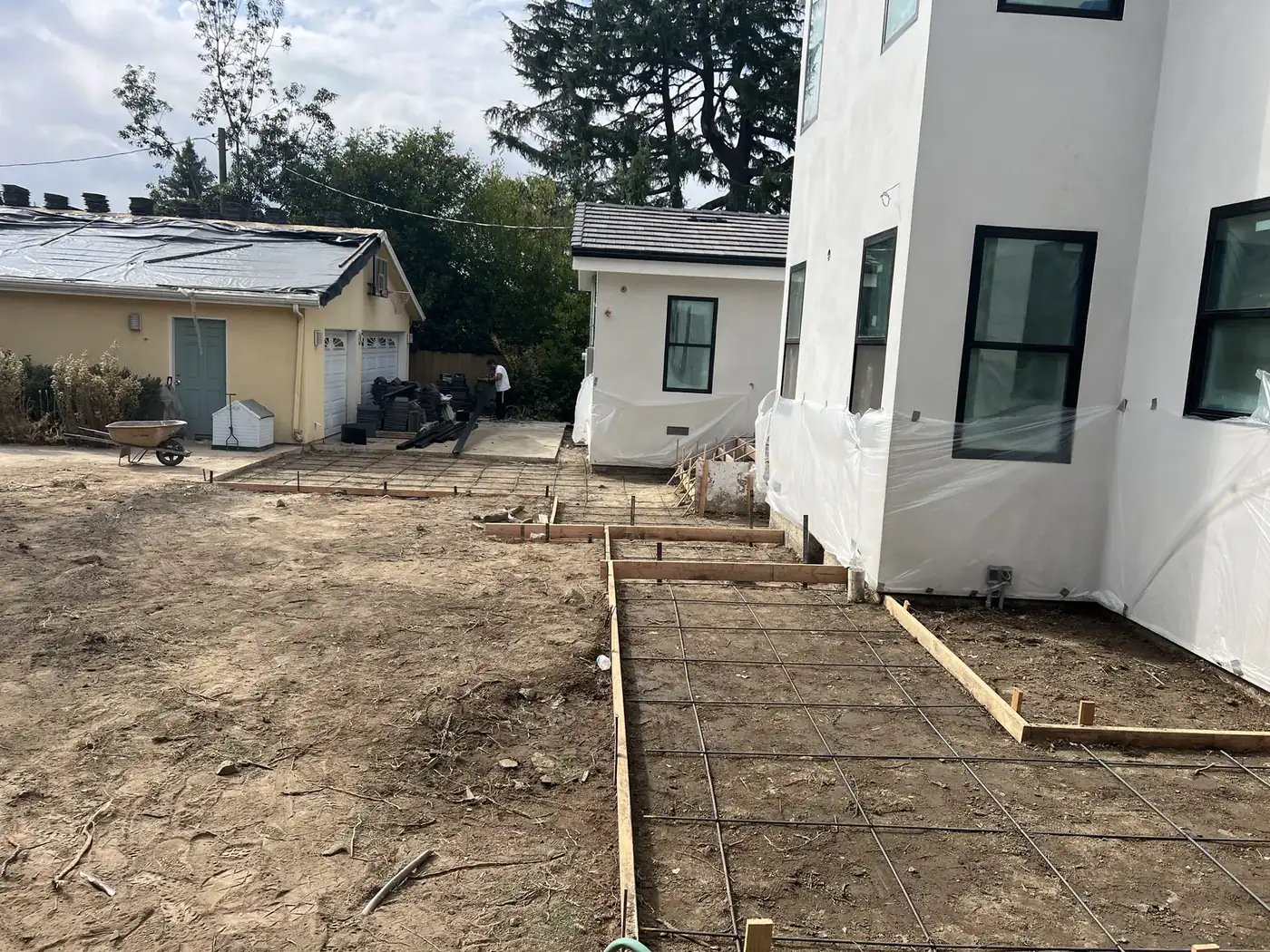 Concrete walkway forms and rebar grid laid out around a PMK Development home in La Cañada Flintridge