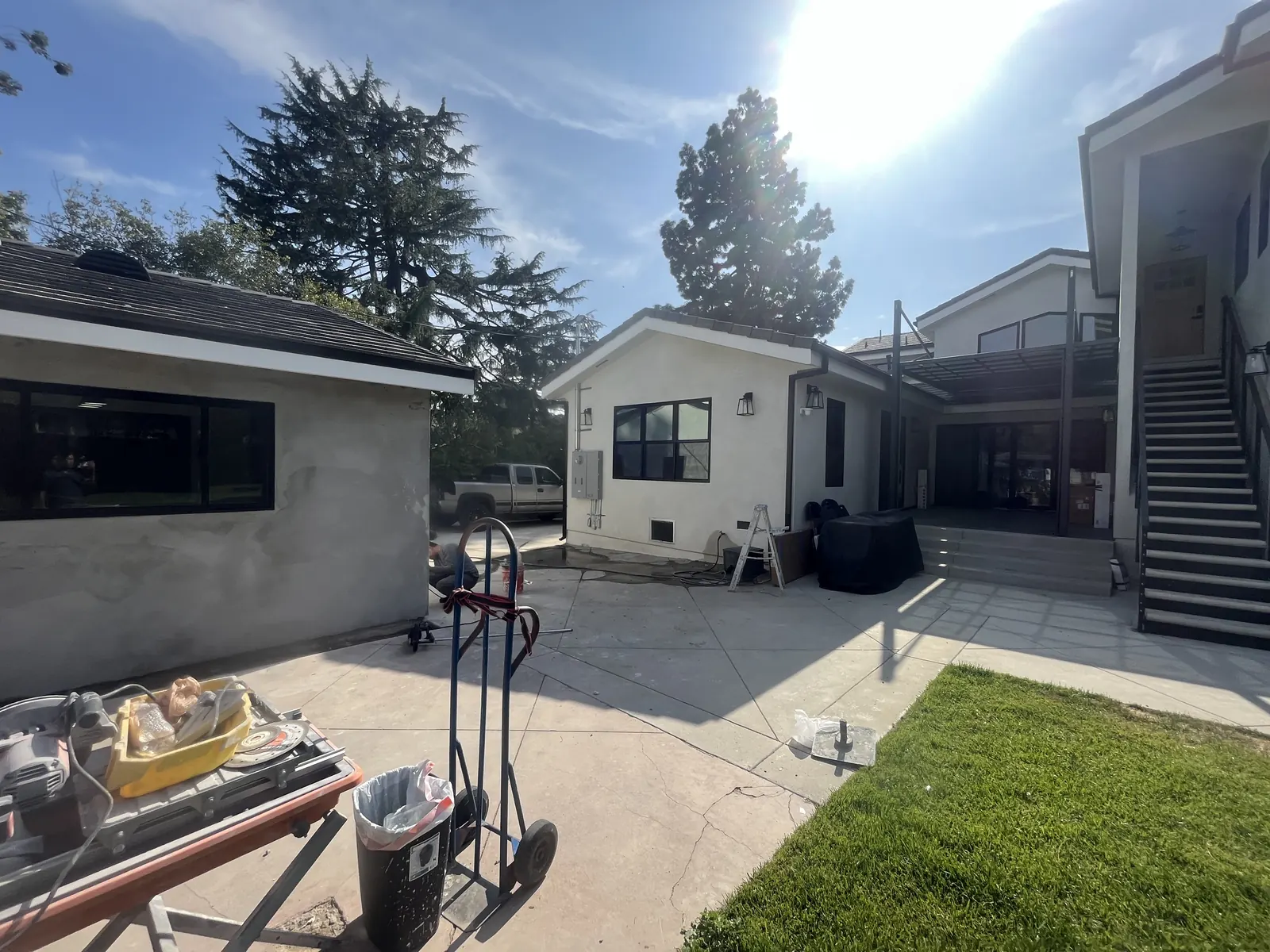 Stuccoed ADU and rear courtyard flatwork taking shape behind the main house at a PMK Development project in La Cañada Flintridge
