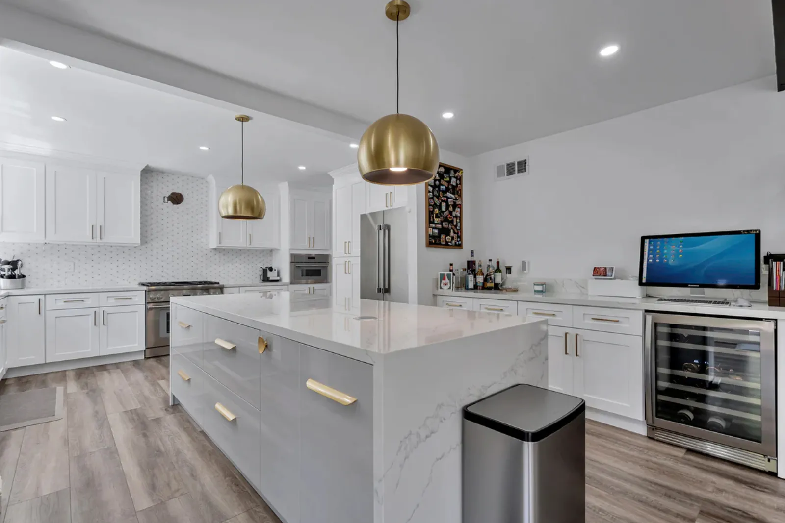Finished kitchen island with pendant lighting and a wine cooler from a PMK Development project on Glenwood Avenue in Fullerton