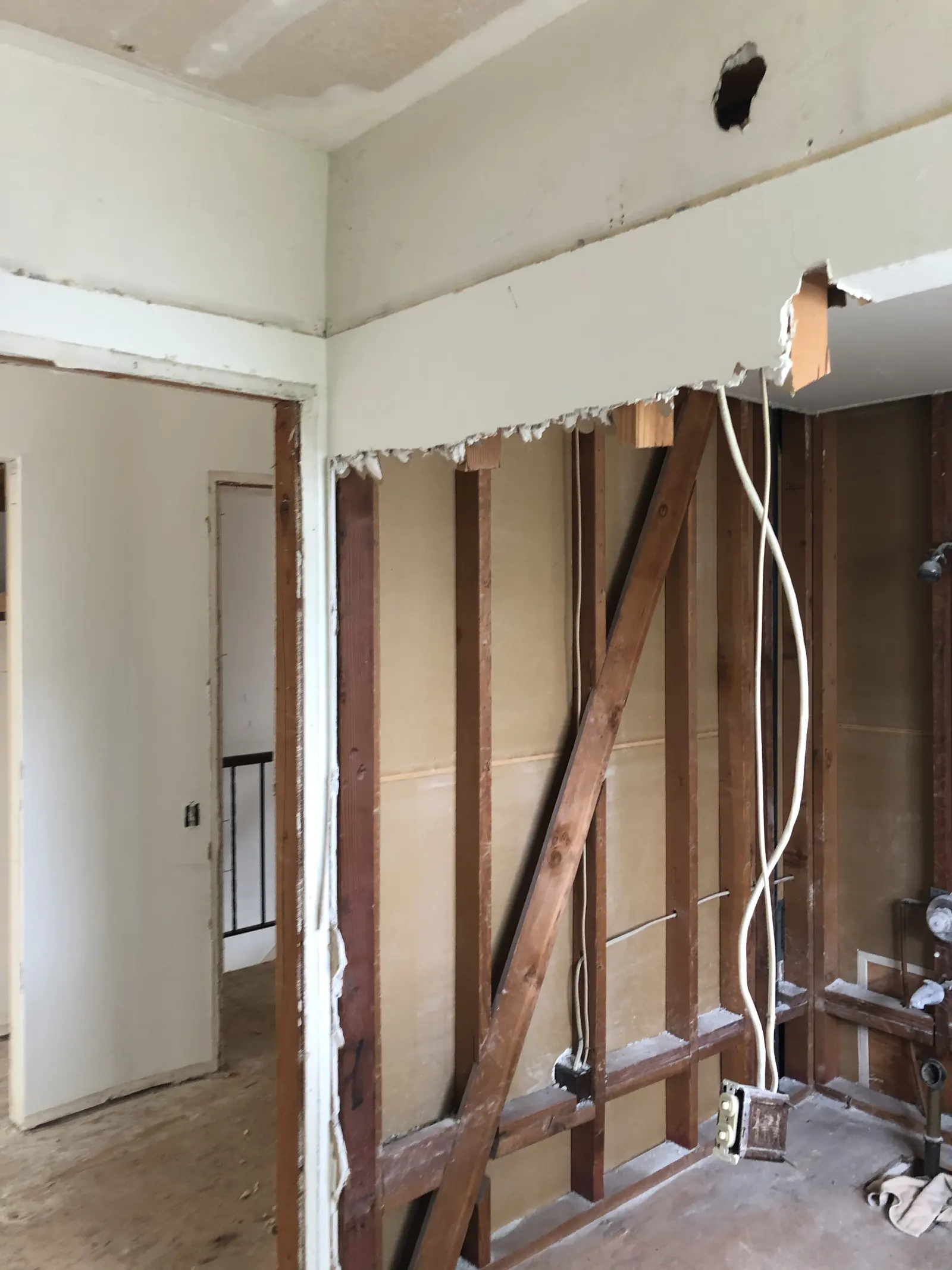 Master bathroom wall opened to the studs with original plumbing exposed at the PMK home-remodel project on Glenwood Avenue in Fullerton.