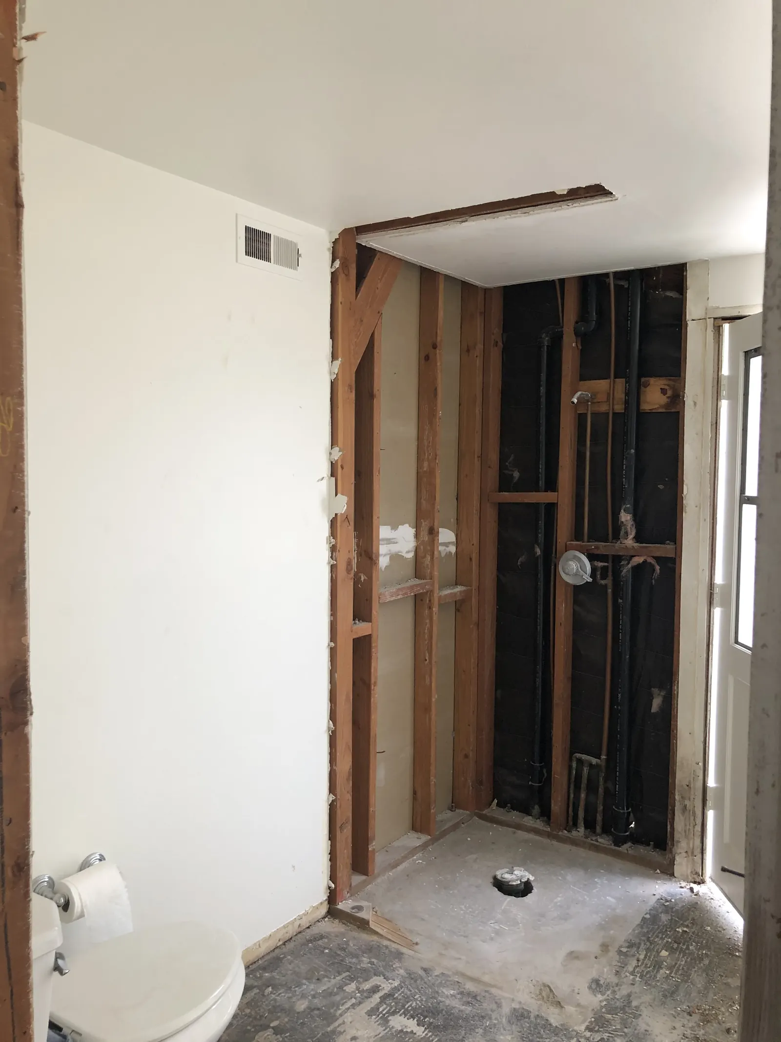 Downstairs bathroom ceiling opened to expose drain and water lines during the PMK home remodel on Glenwood Avenue in Fullerton.