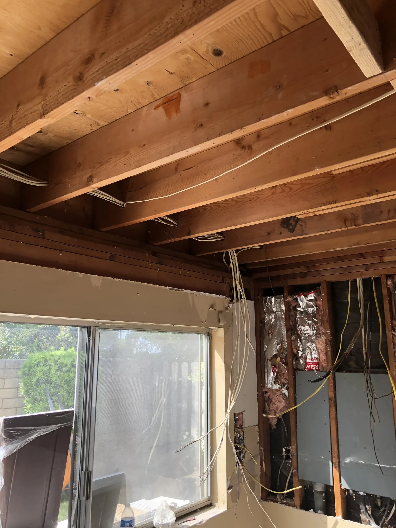 Fresh drywall on the kitchen sink wall with capped water supply lines at the PMK home remodel on Glenwood Avenue in Fullerton.