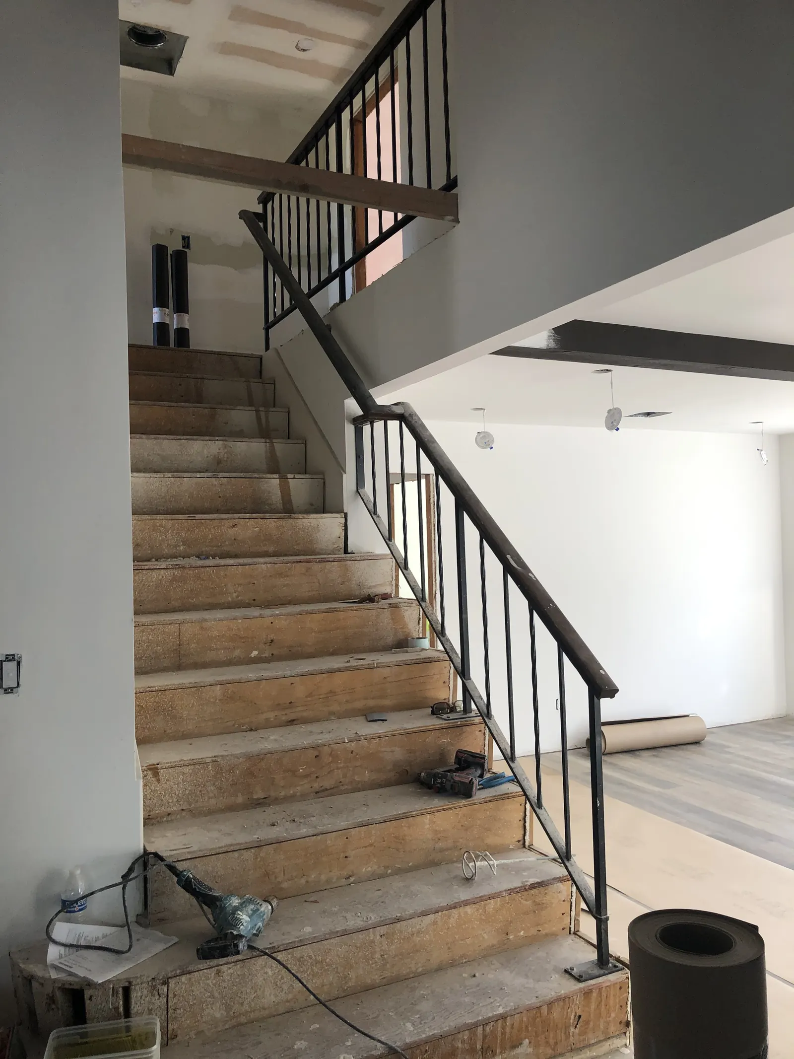 Stairwell with new drywall and recessed lighting cans being fitted during the PMK home remodel on Glenwood Avenue in Fullerton.