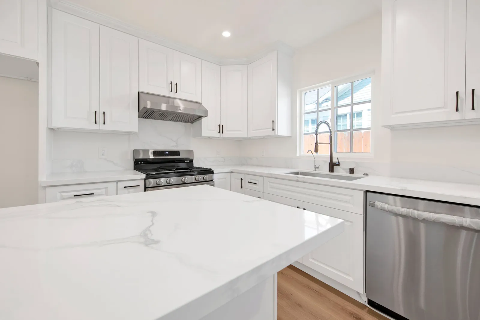 Hobart Blvd remodel, finished white kitchen with quartz island, Los Angeles