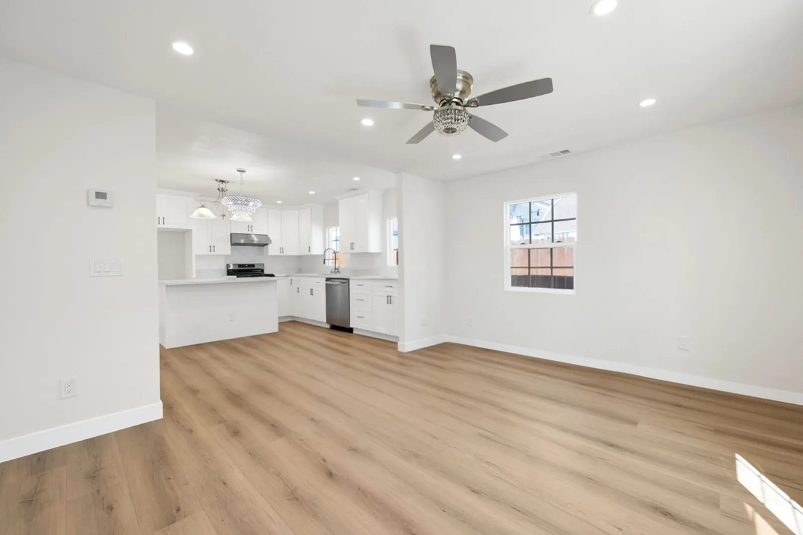 White shaker kitchen anchoring the remodeled open plan at a PMK Development project in Los Angeles