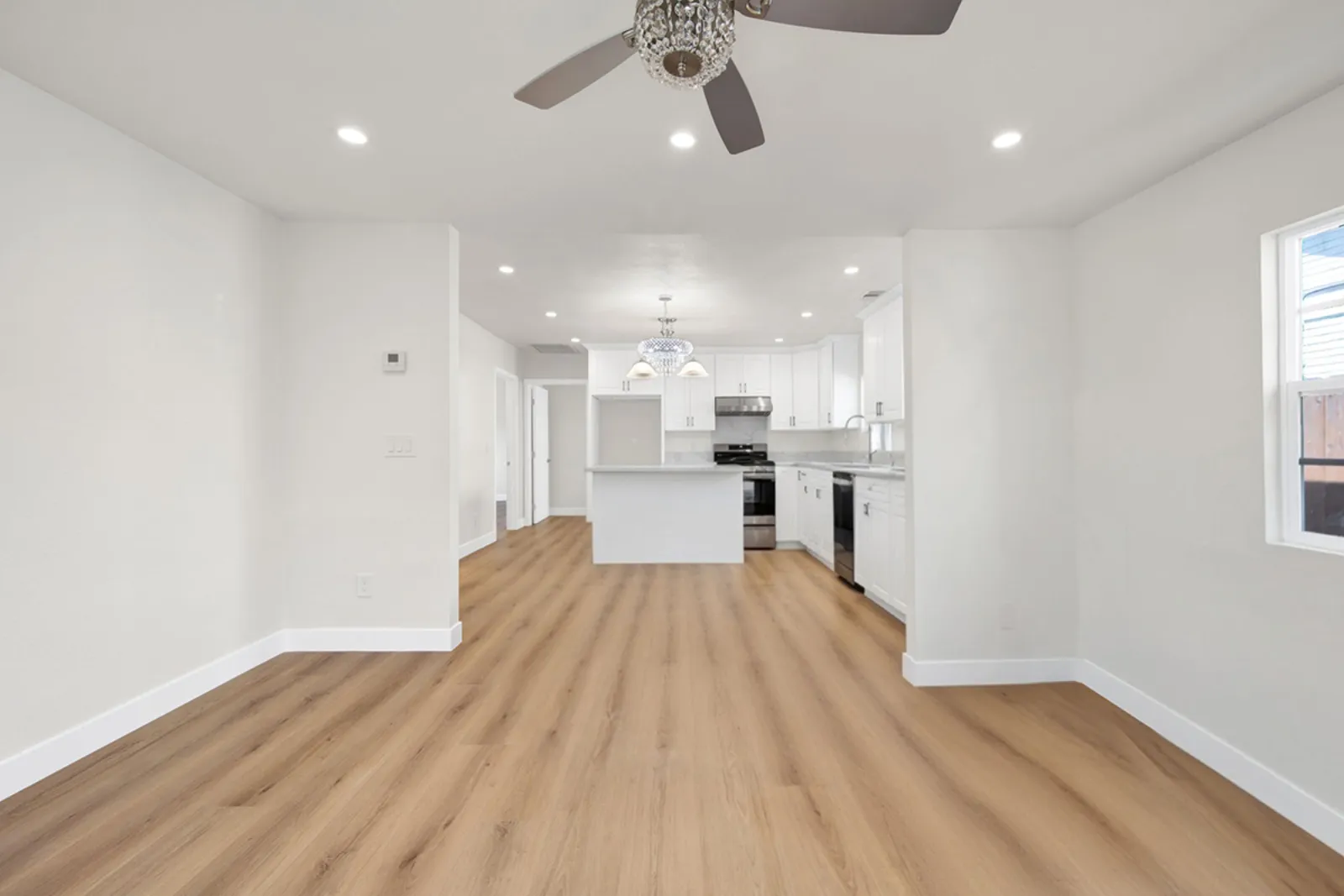 Long sightline from the living area to the new white kitchen and island - Hobart project, Los Angeles