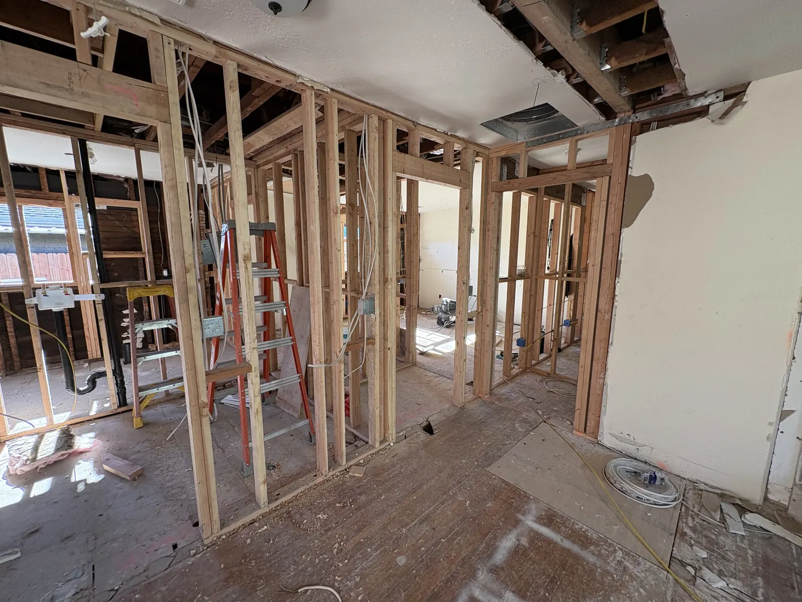 Interior stud framing with exposed ceiling ductwork during the structural phase of PMK's open-concept remodel on Hobart Blvd in Los Angeles.
