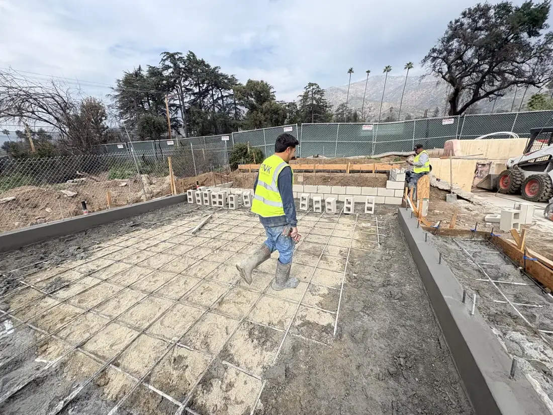 A PMK Development crew member working on a rebar-tied foundation slab in Altadena, California