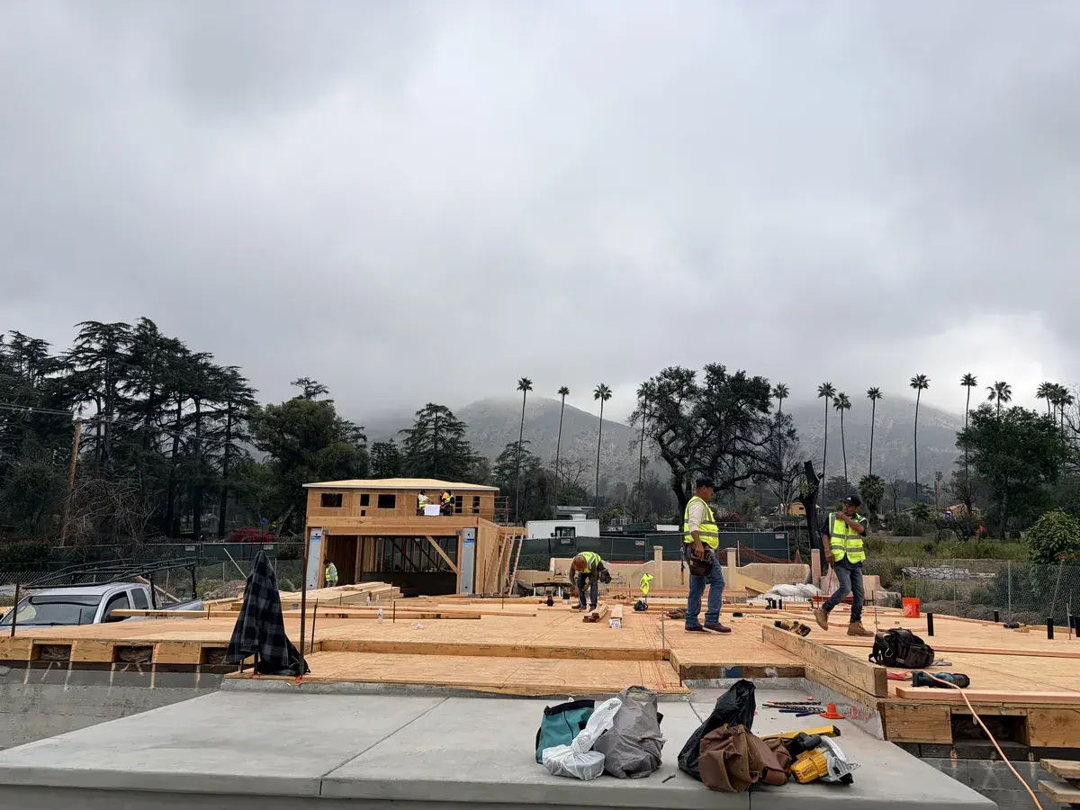 PMK Development crew members setting floor framing on a build site in Altadena, California
