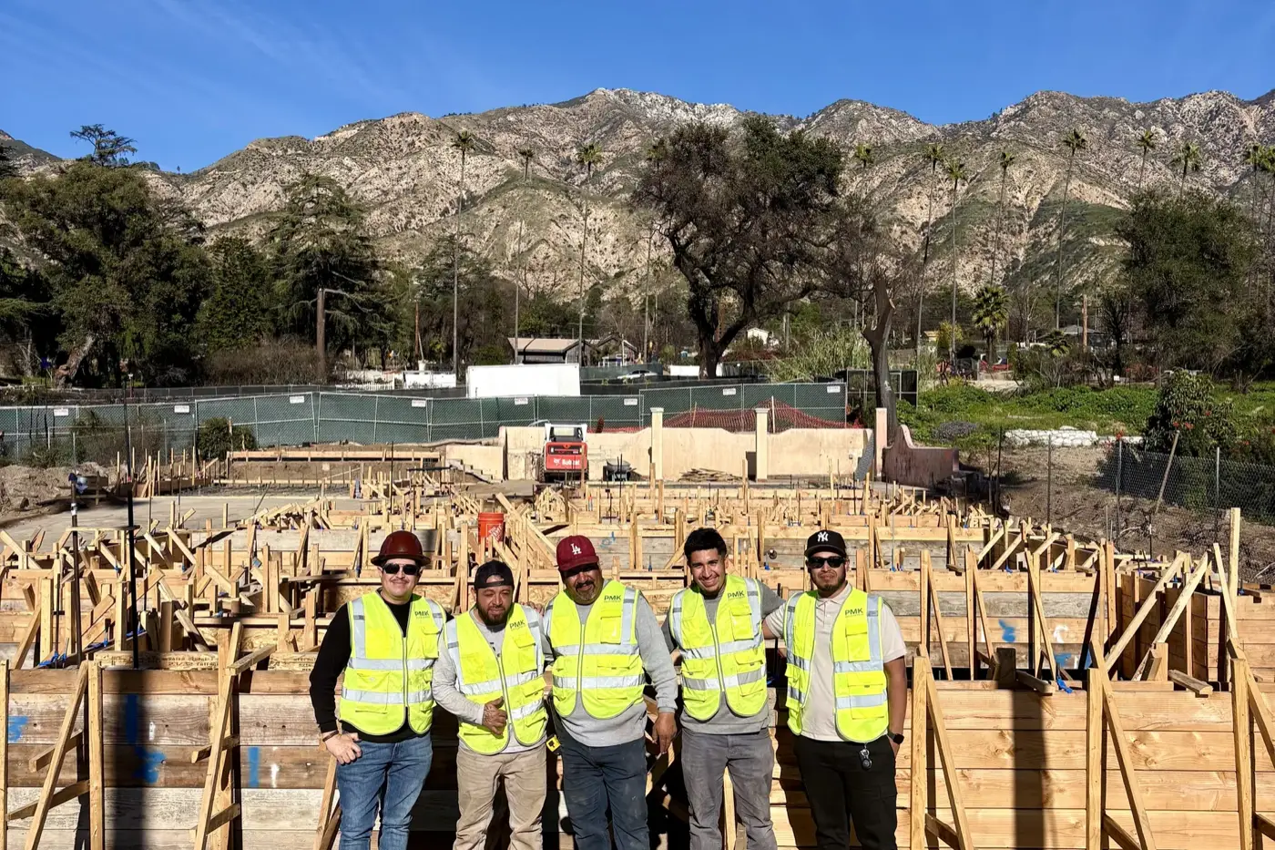 The PMK Development crew in high-visibility vests on a framing site in Altadena, California