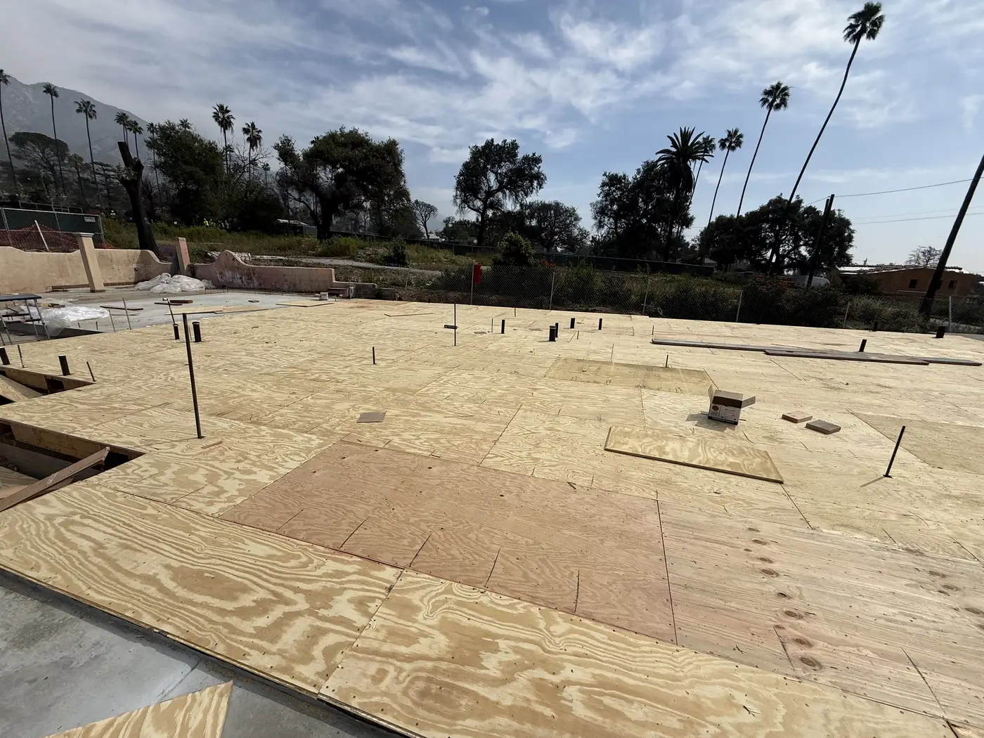 New floor sheathing laid over the ADU foundation on day one of PMK Development's Las Flores Drive rebuild in Altadena.