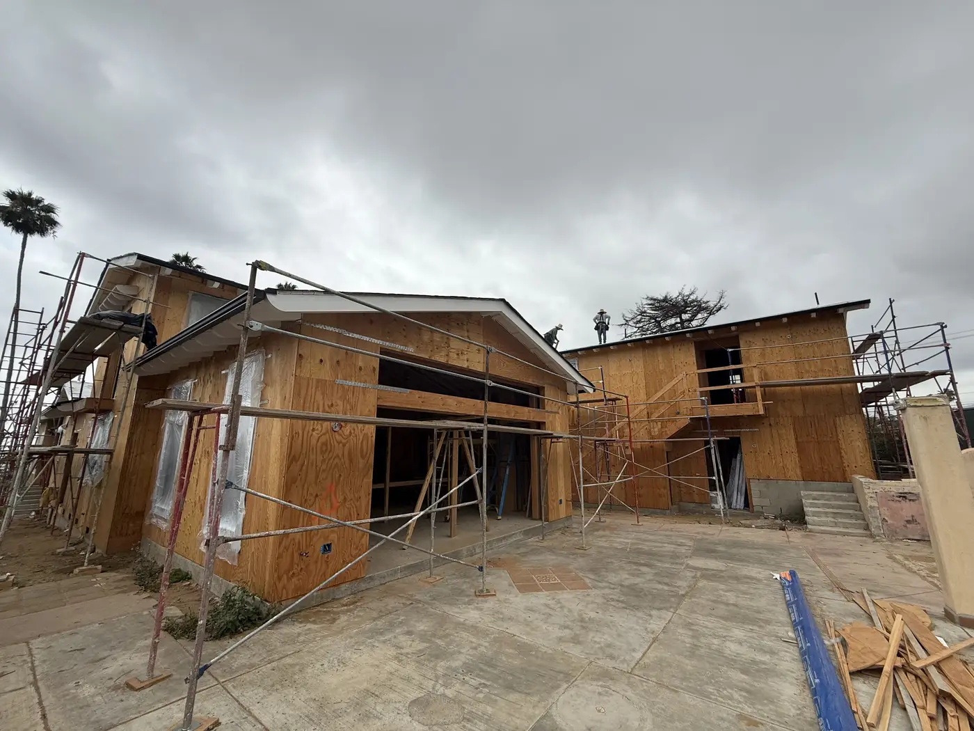 New windows installed and exterior wrapped, with scaffolding along the Las Flores Drive home in Altadena.