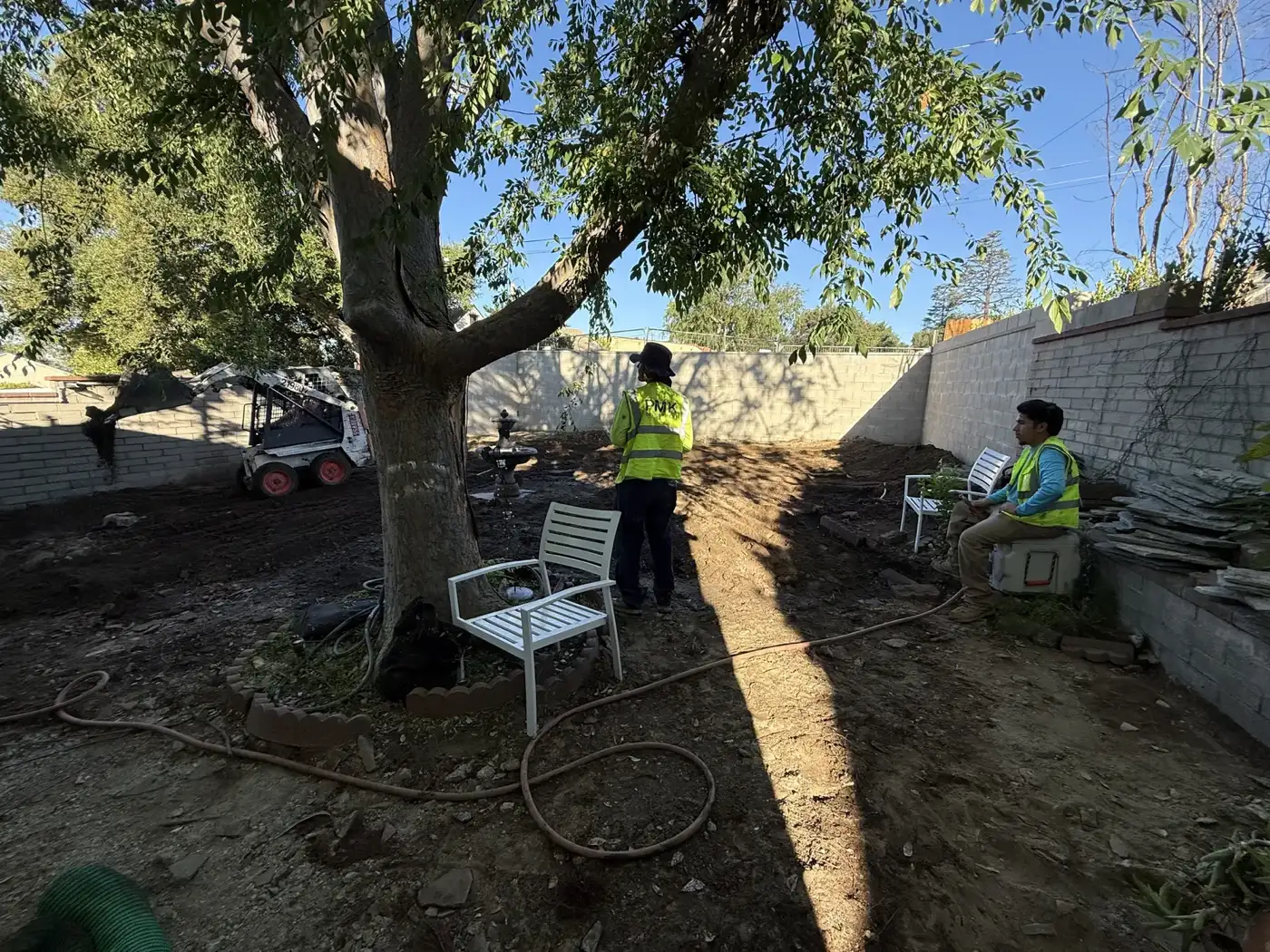 Crew grading and compacting the pad with the San Gabriel mountains behind, at PMK's Mt. Curve Avenue project.