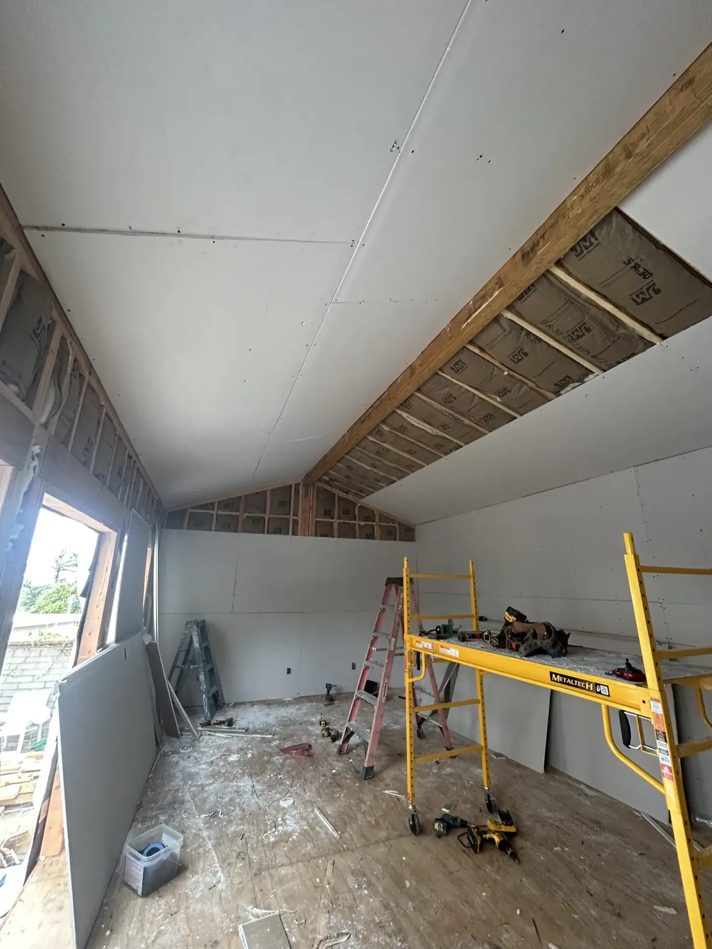 Drywall hung with a rolling scaffold in the vaulted interior at PMK's Altadena project.