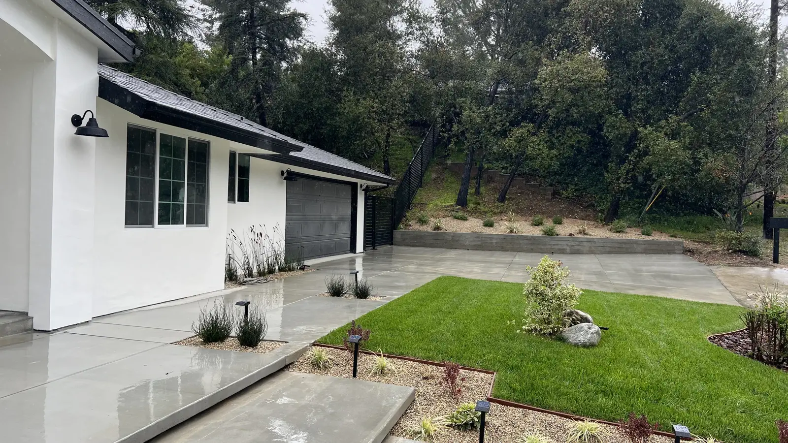 Finished concrete hardscape walkway, drought planting beds and lawn at a PMK Development project in La Cañada Flintridge